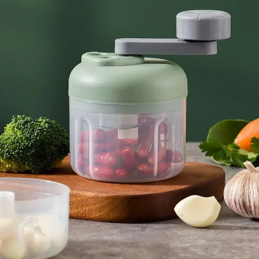 3-speed manual vegetable chopper in green with a hand-crank, perfect for chopping garlic, nuts, and vegetables. Compact, modern design for kitchen prep.