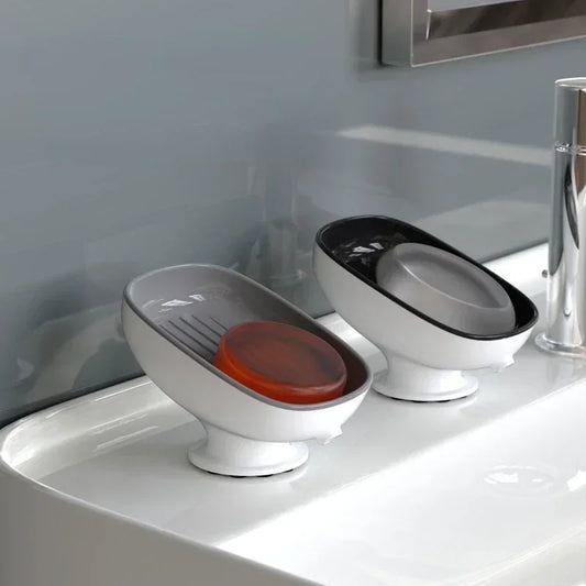 Suction cup soap dish with a drainage feature, available in blue, red, and gray – perfect for bathrooms and kitchens.