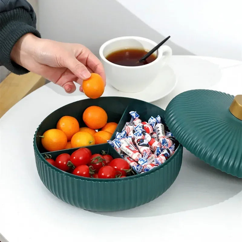 Round multi-compartment serving tray filled with fruits and candies, featuring a stylish lid, perfect for organizing snacks